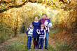 © Irina Schmidt - Portrait of young parents with three children. Mother, father, two kids brothers boys and little cute toddler sister girl having fun together in autumn forest. Happy family of five