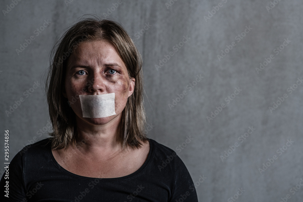 Beaten up woman victim of domestic violence and abusewith covered her mouth - obrazy, fototapety, plakaty 