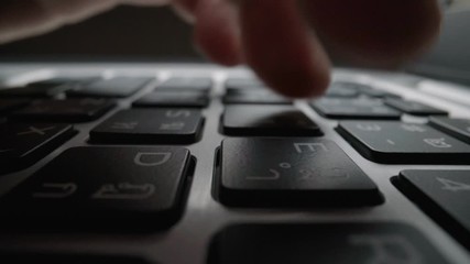 Wall Mural - close-up man typing on computer keyboard with hands and fingers. macro soft focus dolly shot. comput