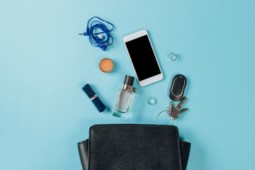 Wall Mural - Contents of woman's bag.Top view of Women bag and lady stuff with copyspace on pink background