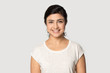 Leinwandbild Motiv Headshot portrait of smiling indian girl posing in studio