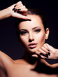 © Valua Vitaly - Face of a beautiful girl with fashion makeup and black nails