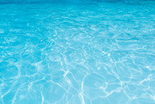 Blue Water Surface In Swimming Pool With Sun Reflection,  Ripple Wave In Pool For Background And Abstract