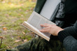 © bo.kvk - Thoughtful young man tourist sitting and reading book in touristic tent in forest