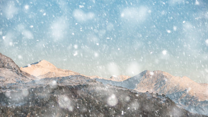 Beautiful Winter sunrise landscape image of Mount Snowdon and other peaks in Snowdonia National Park in heavy snow storm