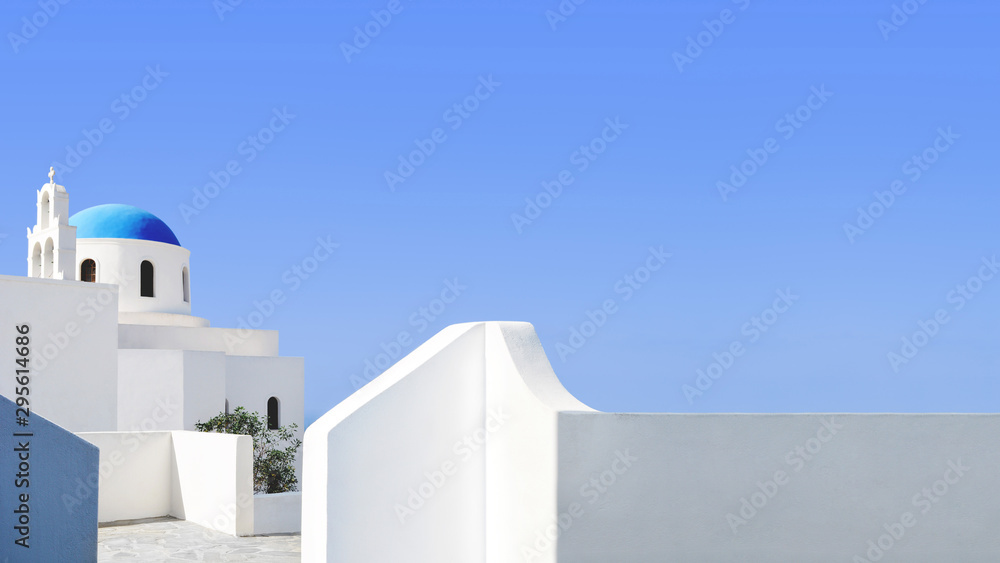 Santorini blue dome and whitewashed structures on light blue sky - obrazy, fototapety, plakaty 