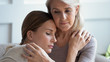 © fizkes - Loving worried older 60s mother comforting sad adult daughter