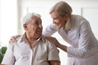 © fizkes - Senior man clinic patient interacting with nurse in white coat