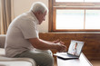 © fizkes - Senior man video chats with doctor online in telehealth visit