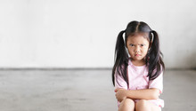 Asian Child Cute Touchy Or Kid Girl Sitting Face Frown And Angry Aggressive With Sad Or Have Problems And Lonely Unhappy Or Wayward On City Street And Footpath At Home Or Nursery And School With Space