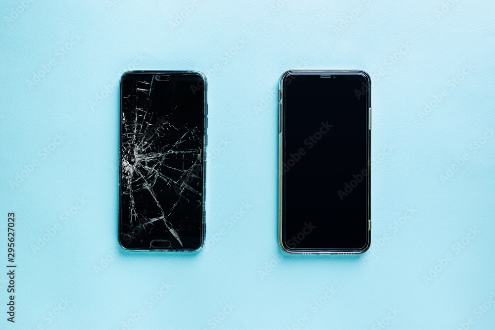 Modern touch screen smartphone with broken screen and new one on blue background, top view - obrazy, fototapety, plakaty 
