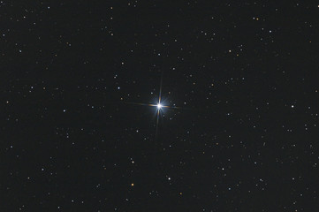 closeup of the star sadr in cygnus constellation, with many stars as background in the deep space.