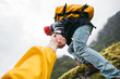 POV view on brave tourist helping his active friend holding to hand climbing to rock. Two travelers climb to mountains lifestyle outdoor vacation