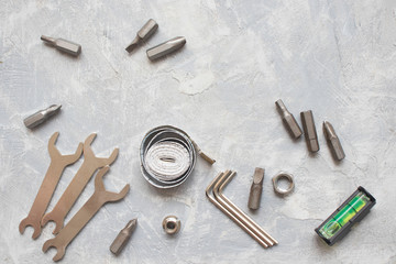 tools, wrenches, hex wrenches on concrete background, top view