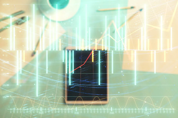 Double exposure of forex graph on digital tablet laying on table background. Concept of market analysis