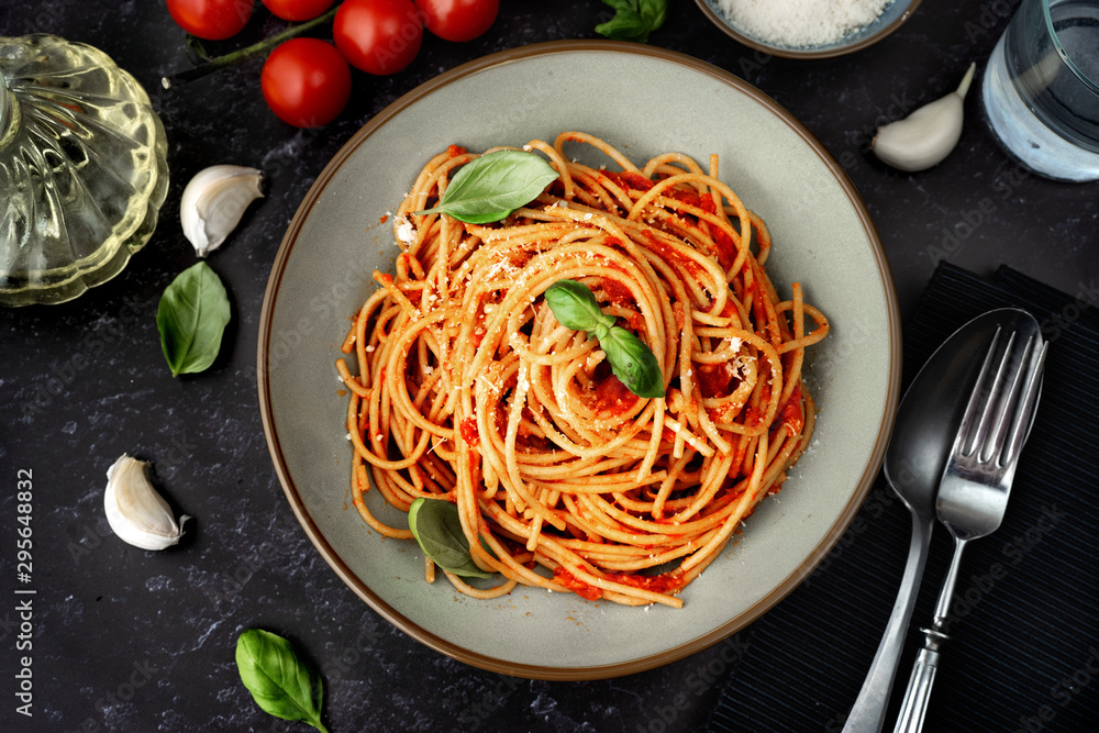 Close up of spaghetti with tomato sauce on black background - obrazy, fototapety, plakaty 