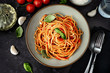Close up of spaghetti with tomato sauce on black background
