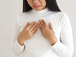 gastroesophageal reflux disease or GERD breathing difficulty in asian woman. She use hand touching chest on isolated white background use for health care concept.