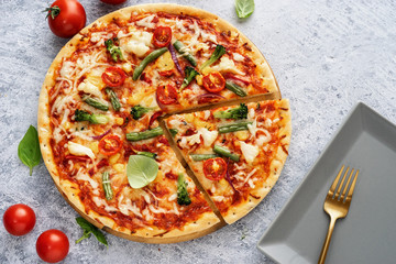 Wall Mural - Top view of fresh vegetarian pizza on light blue background