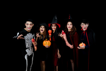 Young Asian people, a group of five persons, in scary costumes. Group of friends having fun at a party in a nightclub to celebrate Halloween festival.