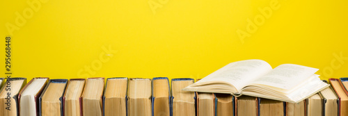 Open book, hardback books on wooden table Poster Mural XXL
