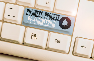 Text sign showing Business Process Re Engineering. Business photo showcasing the analysis and design of workflows White pc keyboard with empty note paper above white background key copy space