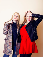 lifestyle and people concept: Fashion portrait of two stylish girls best friends, over white background. Happy time for fun