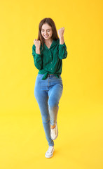 Happy young woman on color background