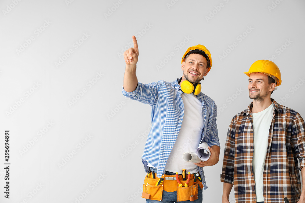 Portrait of architects on light background