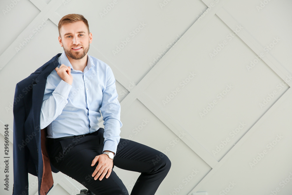 Portrait of handsome businessman on light background
