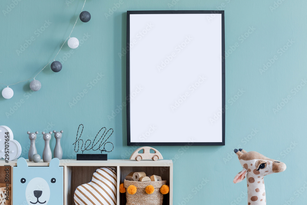 Stylish scandinavian newborn baby room with wooden cabinet, toys, mock up poster frame and children's accessories. Modern interior with eucalyptus background wall and cottona balls. Modern home decor. - obrazy, fototapety, plakaty 