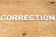 Word correction on a wooden table
