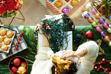 Unhappy Trendy Female Holding Tangled Christmas Lights