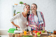 © undrey - Women preparing healthy food playing with vegetables in kitchen having fun concept dieting nutrition