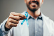 © kleberpicui - Prostate Cancer Awareness. Doctor man holding light Blue Ribbon for supporting people living and illness. Men Healthcare and World cancer day concept