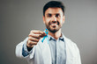 © kleberpicui - Prostate Cancer Awareness. Doctor man holding light Blue Ribbon for supporting people living and illness. Men Healthcare and World cancer day concept