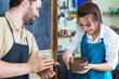 © danmorgan12 - Claymaking Process Concept. Two Cheerful Professional Ceramists During a Process of Clay Preparation on Tables in Workshop.