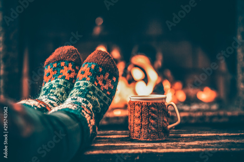 Feet in woollen socks by the Christmas fireplace Poster Mural XXL