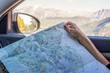 woman holding map while driving in Rocky mountain national park in Colorado