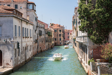 Panoramic view of Venice narrow canal with historical buildings and boats