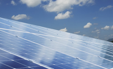 Wall Mural - eco technology solar panel with sun and blue sky background. concept clean energy in nature
