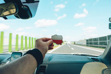 Wall Mural - man holding sticker with poland flag in front of highway