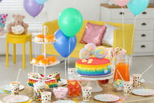 Bright Birthday Cake And Other Treats On Table In Decorated Room