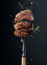 Grilled Ribeye Beef Steak With Rosemary On A Black Background.