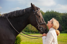 Middle Aged Woman Close With Her Horse