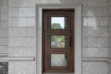 Dark Brown Wooden Door With Wood Carving And Tinted Glass
