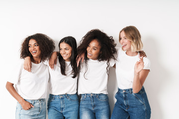 Wall Mural - Cheery young women multiracial friends posing isolated