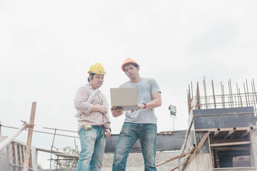 Two young man architect on a building construction site