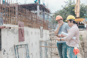 Two young man architect on a building construction site