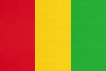 Guinea national fabric flag, textile background. Symbol of african world country.